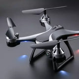 Grey quadcopter drone with front camera and four propellers