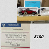 Red and black diecast car model in clear display tray