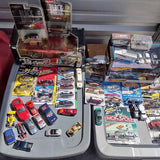 Diecast car toy lot with multiple blister-pack vehicles and a few loose cars