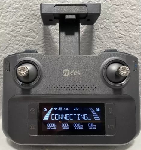 GPS drone controller remote with twin thumb joysticks and blue-lit display