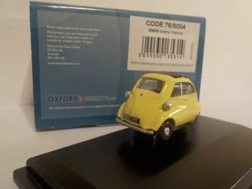 Yellow diecast model car with open roof on stand
