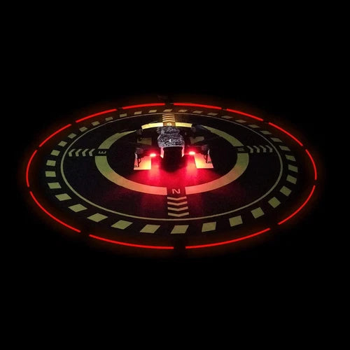 Round drone landing pad with red LED ring and green directional markings