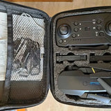 Mini drone kit case interior with controller and stored drone parts
