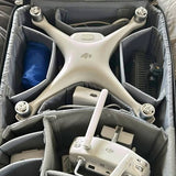 White quadcopter drone with four prop guards and extended antennas in hard case