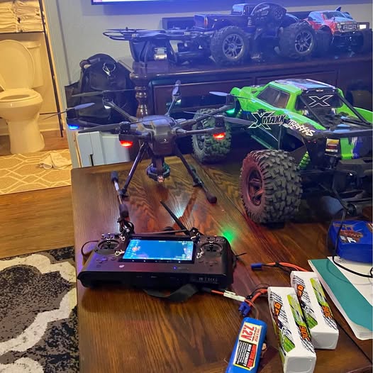 RC off-road drone with green accents and controller display