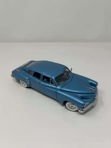 Blue 1:24 scale diecast car model with detailed front grille