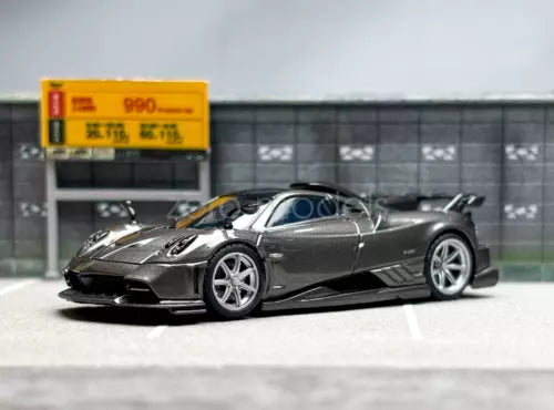 Gray 1:64 scale sports racing diecast car, low front three-quarter view