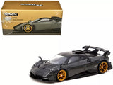 Gray diecast race car model with gold wheels, rear wing and front splitter detail