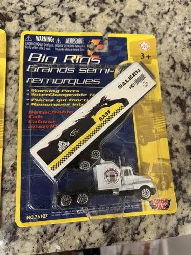 Boxed diecast semi truck and trailer toy with yellow and white accents