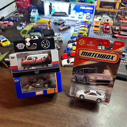 Die-cast car toy, silver car in Matchbox blister packaging with red branding