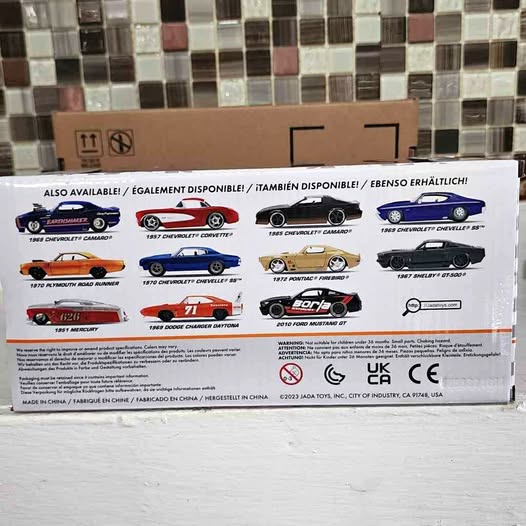 Diecast model car display box with lineup of several classic muscle cars