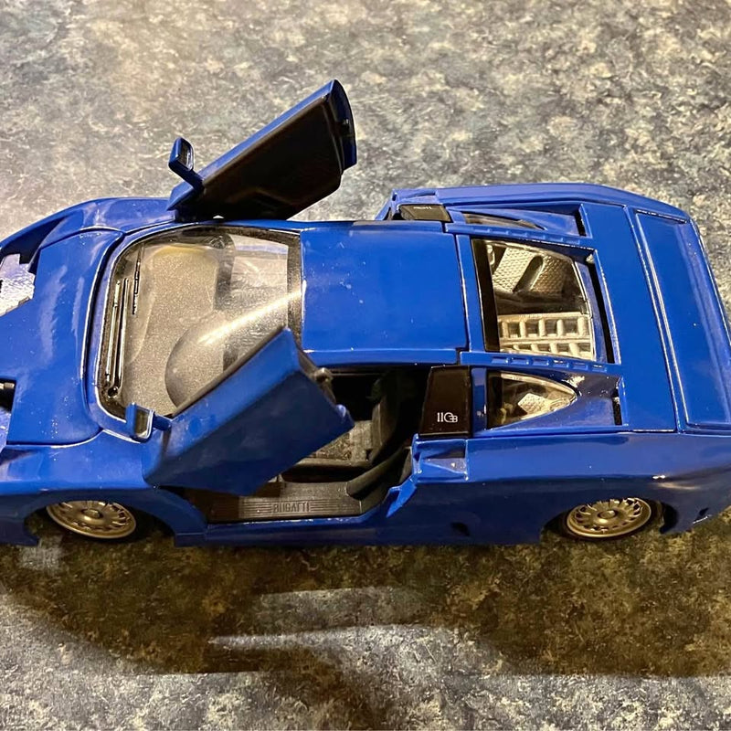 Blue diecast toy collector car with open door and exposed interior