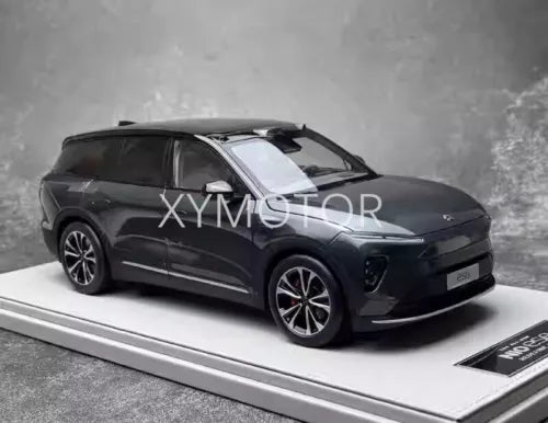 Diecast model car, dark SUV with detailed wheels and grille, left front view