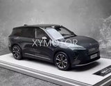 Diecast model car, dark SUV with detailed wheels and grille, left front view