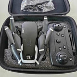 Small camera drone with remote and prop arms in hard case