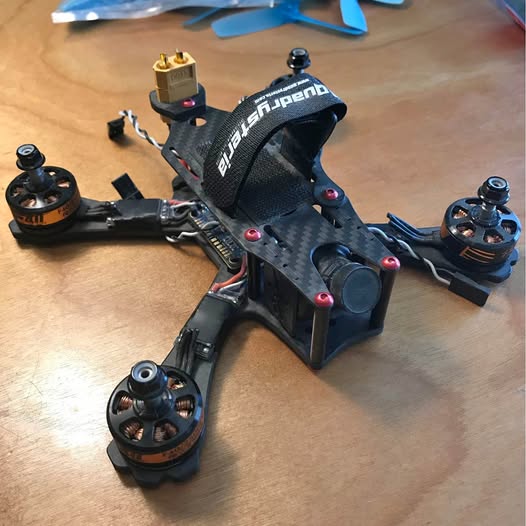 Carbon fiber quadcopter drone with four motor mounts and propeller guards