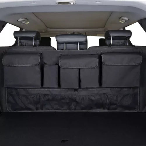 Black diecast model car trunk interior with seatback divider and several storage pockets