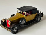 Yellow diecast car model with black roof and maroon interior