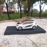 White concept car diecast model on black base, side view