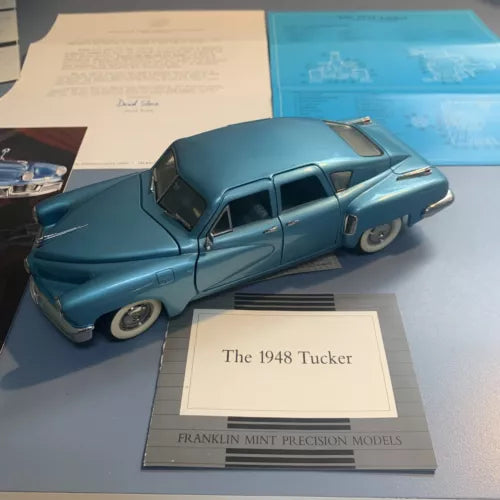 1:24 scale diecast car model, blue with black trim and whitewall tires