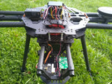 Quadcopter drone frame with visible electronics and flight controller