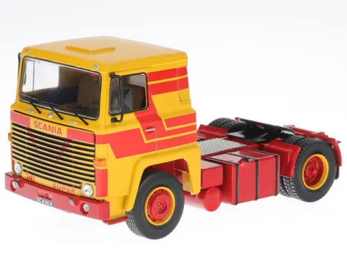 Diecast truck model with yellow cab and red stripes, front view.