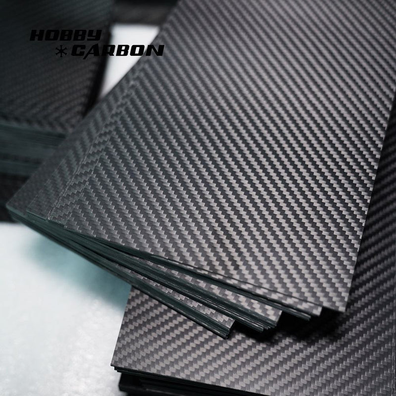 Matte 3K carbon fiber sheet with twill weave, stacked layers, close-up detail