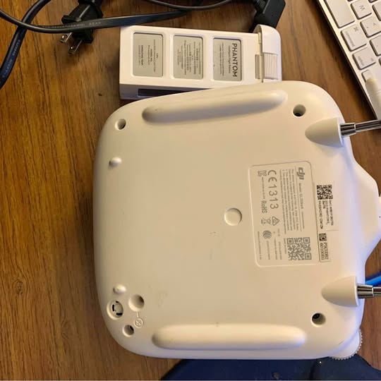 White drone controller back view with two metal antenna mounts and buttons
