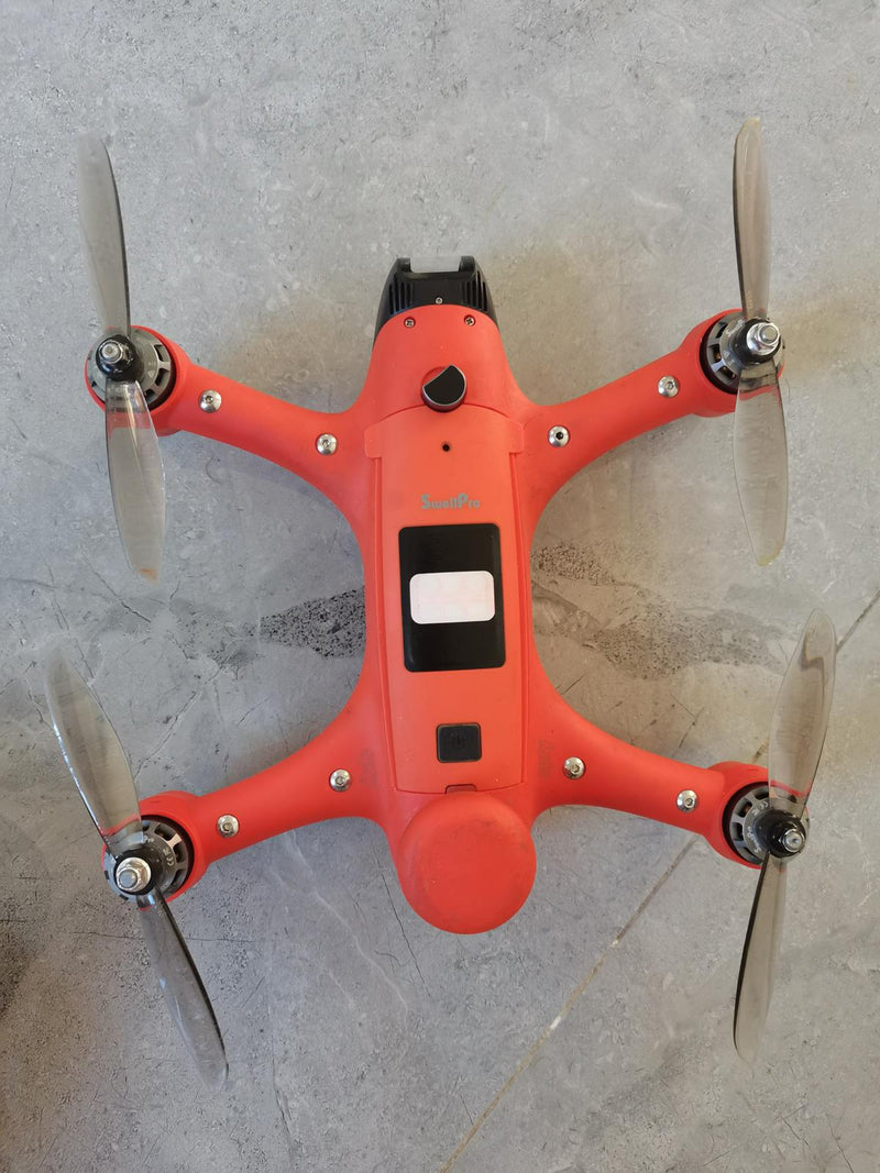 Orange quadcopter drone with four propellers and a front camera window