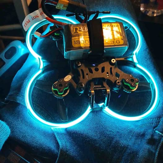 LED quadcopter drone with illuminated prop guards and battery