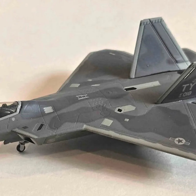 Dark gray F-22 Raptor diecast replica airplane with landing gear detail