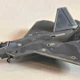 Dark gray F-22 Raptor diecast replica airplane with landing gear detail