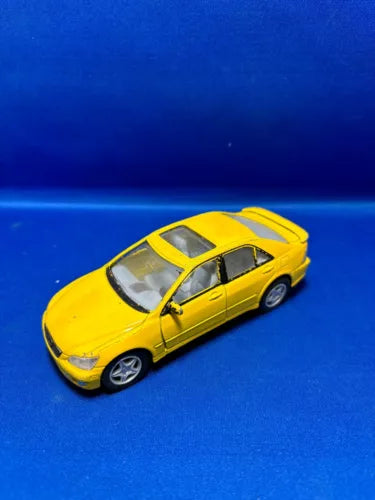 Yellow diecast metal model car, front three-quarter view, 1:36 scale