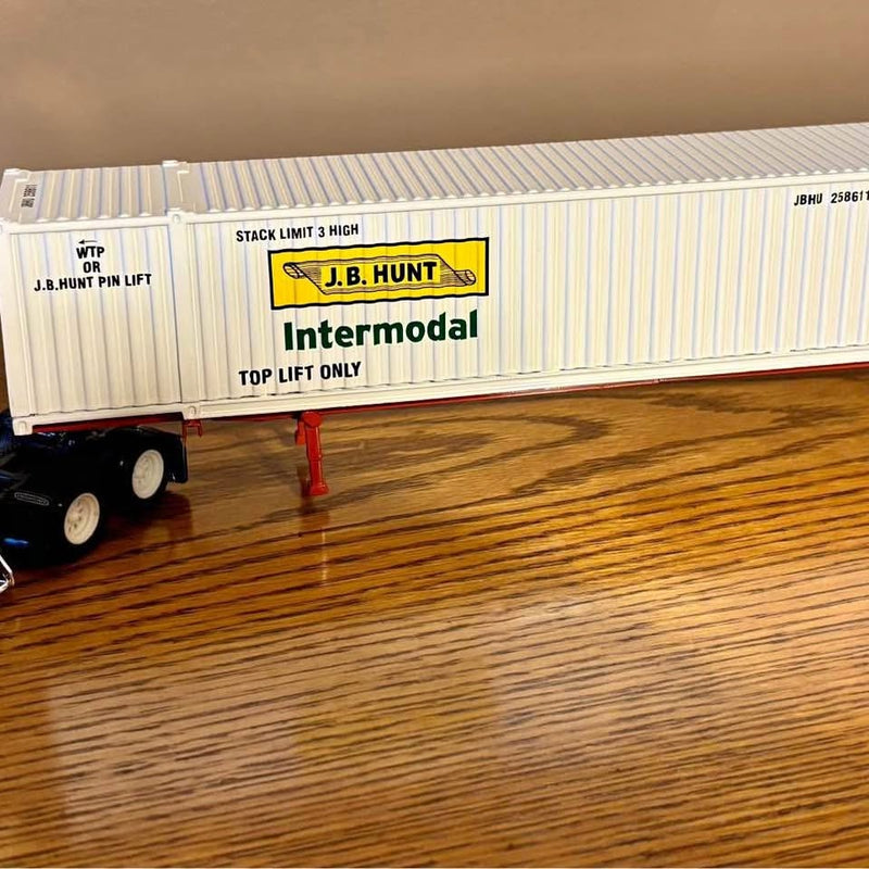 Die-cast J.B. Hunt intermodal trailer with yellow logo and striped sides