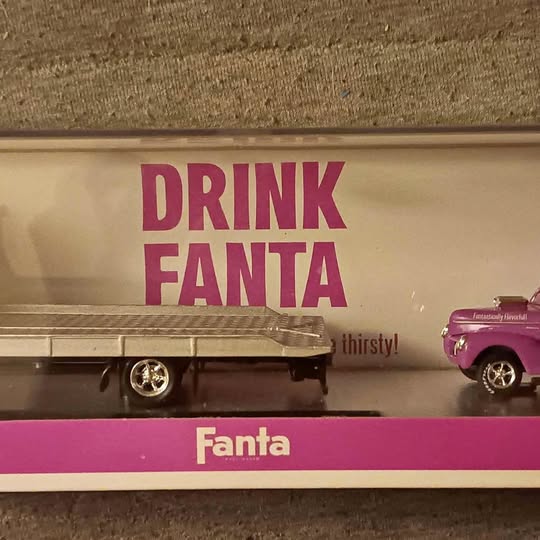 Purple die-cast toy display car with Fanta graphics and Drink Fanta sign