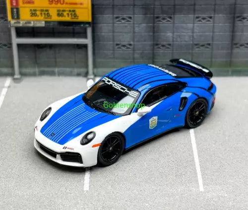 Porsche 911 Turbo S diecast toy car in blue and white, front 3/4 view