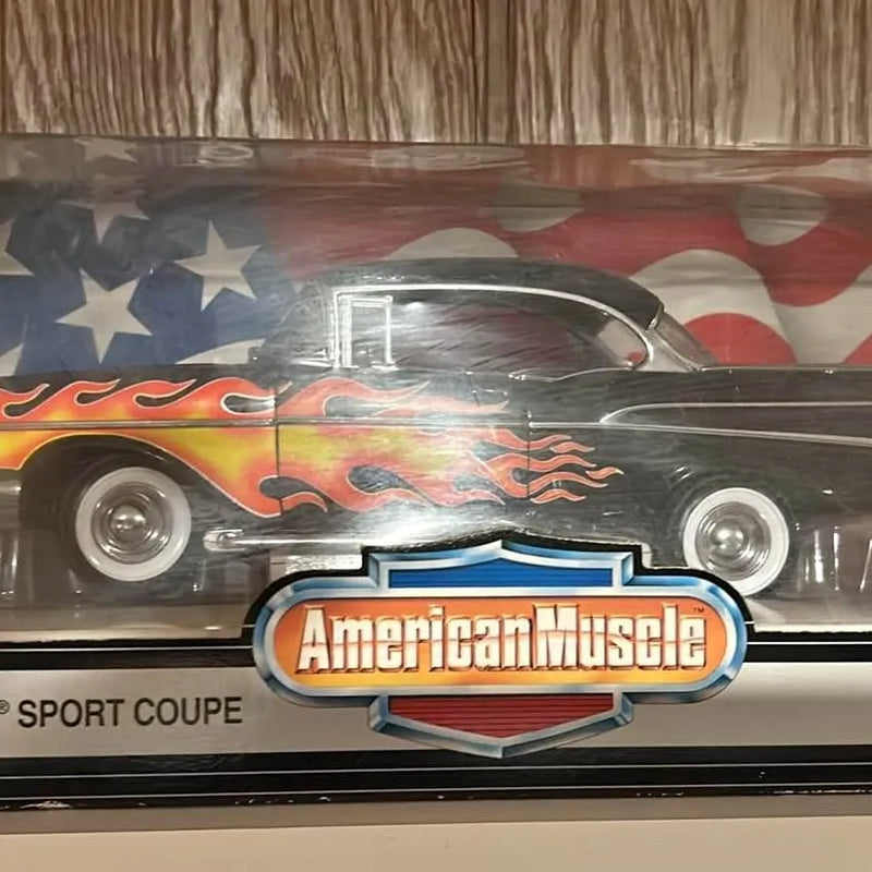 Diecast black car model with red flames and American Muscle front emblem