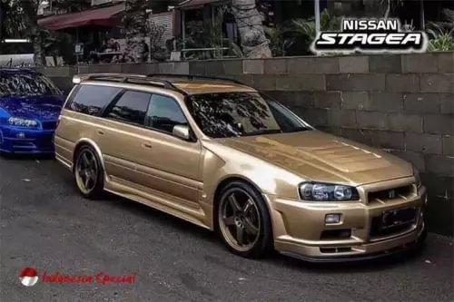 Gold Nissan Stagea WC34 wagon diecast model car, front 3/4 view, black wheels
