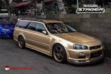 Gold Nissan Stagea WC34 wagon diecast model car, front 3/4 view, black wheels