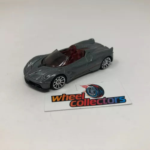 Dark gray 1:64 scale diecast roadster model car with red interior and open top