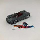 Dark gray 1:64 scale diecast roadster model car with red interior and open top