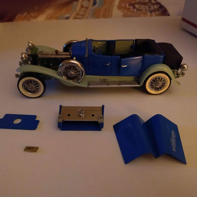 1/24 vintage diecast car in blue and green, with detached parts on display