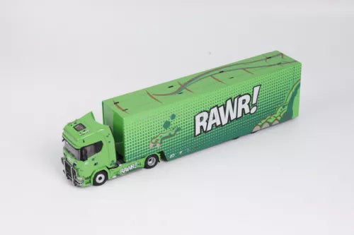 Green diecast toy truck with RAWR! printed trailer, front cab facing left