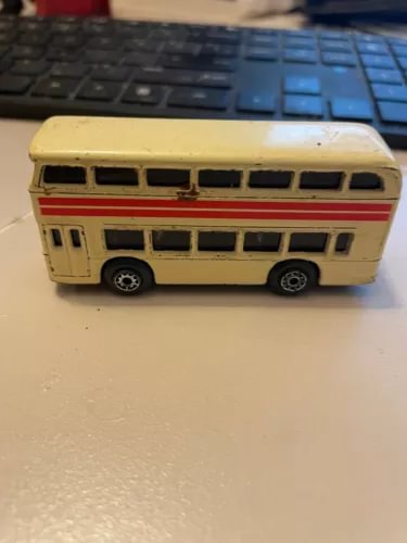Cream double-decker sightseeing bus diecast model, side view with windows
