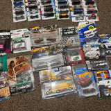 Assorted diecast car toys in blister packs, various colors and designs