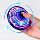 Mini LED UFO spinner drone with multicolor ring, held by fingertip
