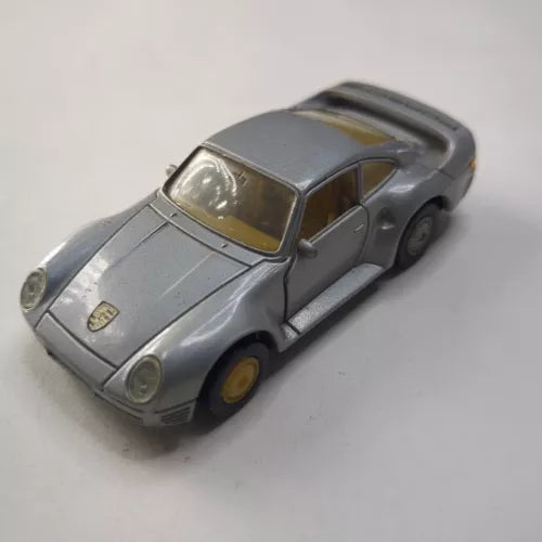 Porsche 959 diecast toy car, silver-gray with detailed front grille and headlights