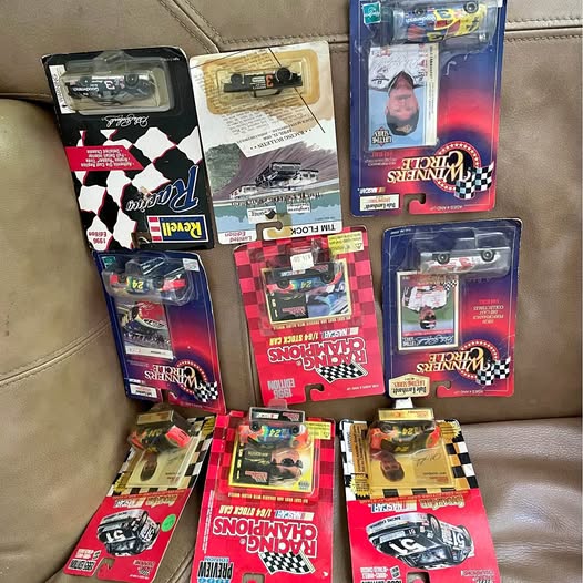 Miniature diecast cars in blister boxes, mixed colors and checkered graphics