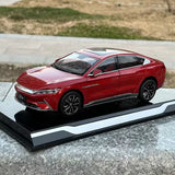 Red 1/18 electric vehicle diecast model car with black wheels on base