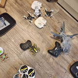 Quadcopter drones with remote controller and small accessories on a floor